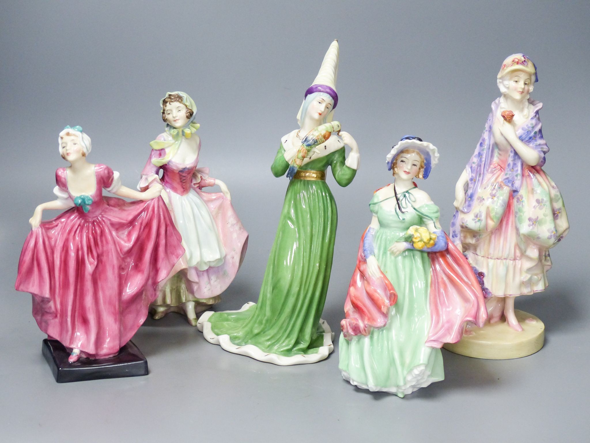 Four Royal Doulton figurines: Phyllis HN1420, Suzette HN1487, Delight HN1772, Lady April HN1965 and another figurine unmarked